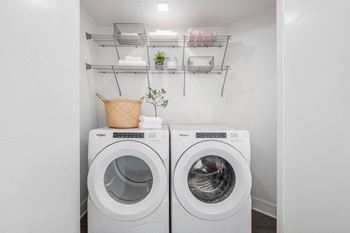 a washer and dryer in a laundry room with white walls